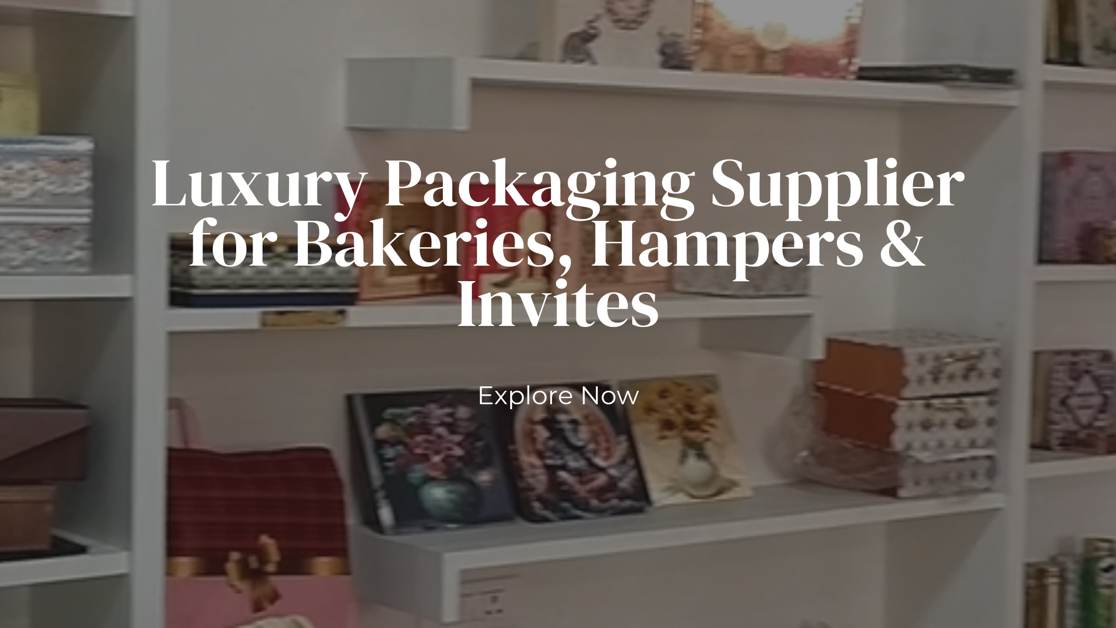 Display shelves with luxury bakery packaging boxes, gifting hampers, and invitation designs inside a premium packaging store.