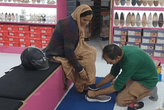 Customer trying comfortable footwear at Nitin Shoes Nirman Nagar Jaipur highlighting better quality at reasonable prices.